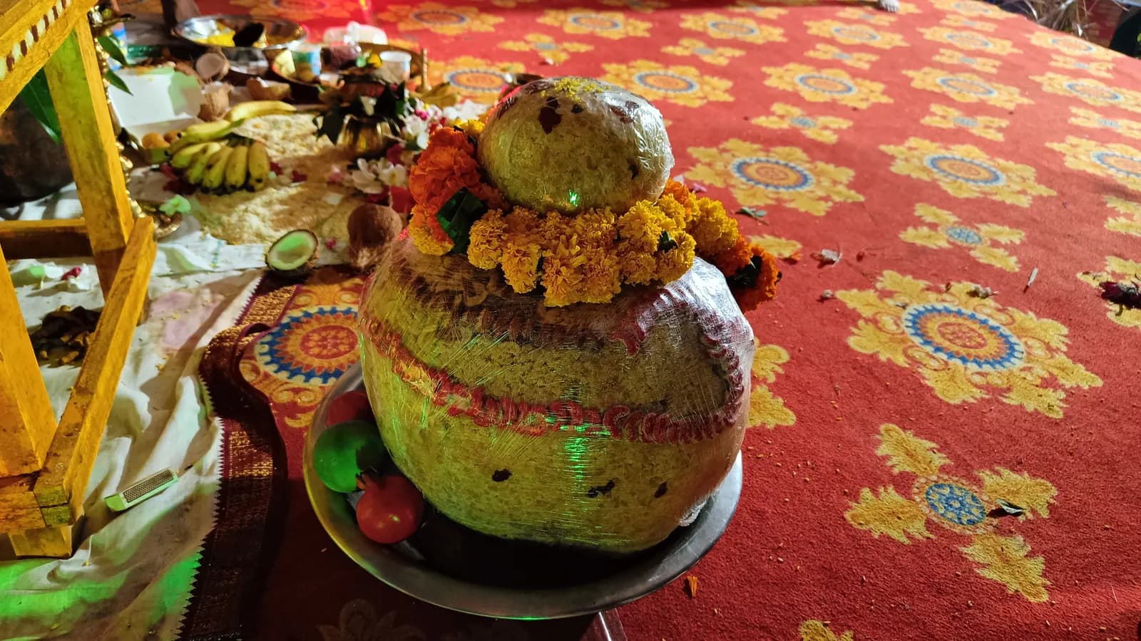 The garlanded prasadam laddu